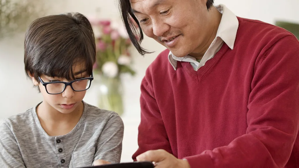 A father and child using a digital tablet together