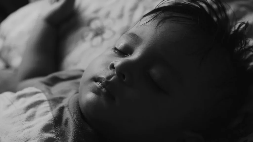 A young child sleeping peacefully in bed